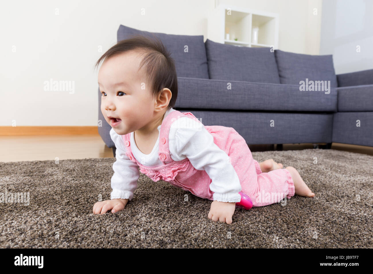 Baby girl creeping at home Stock Photo Alamy