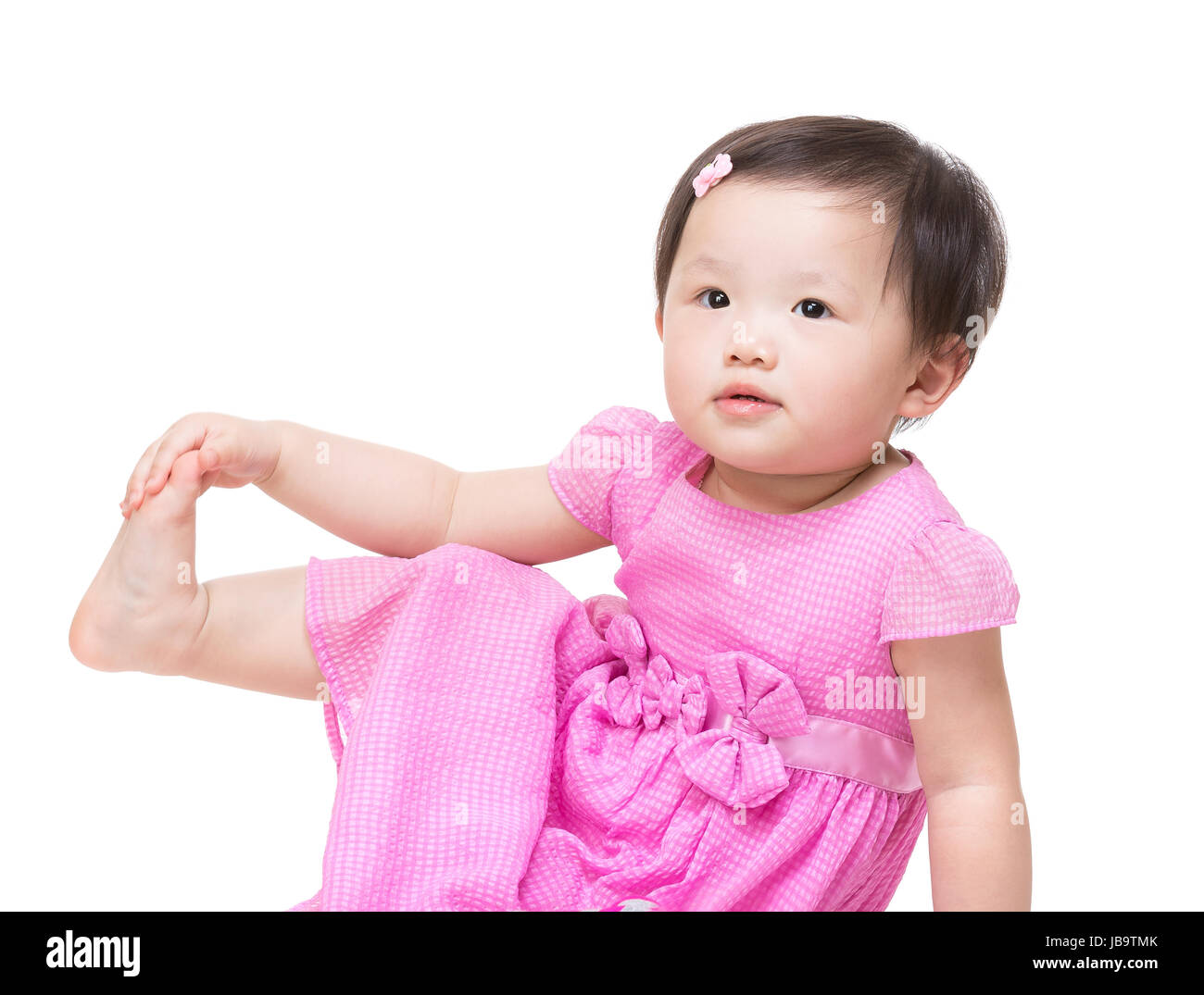 Asia little girl touch her feet Stock Photo - Alamy