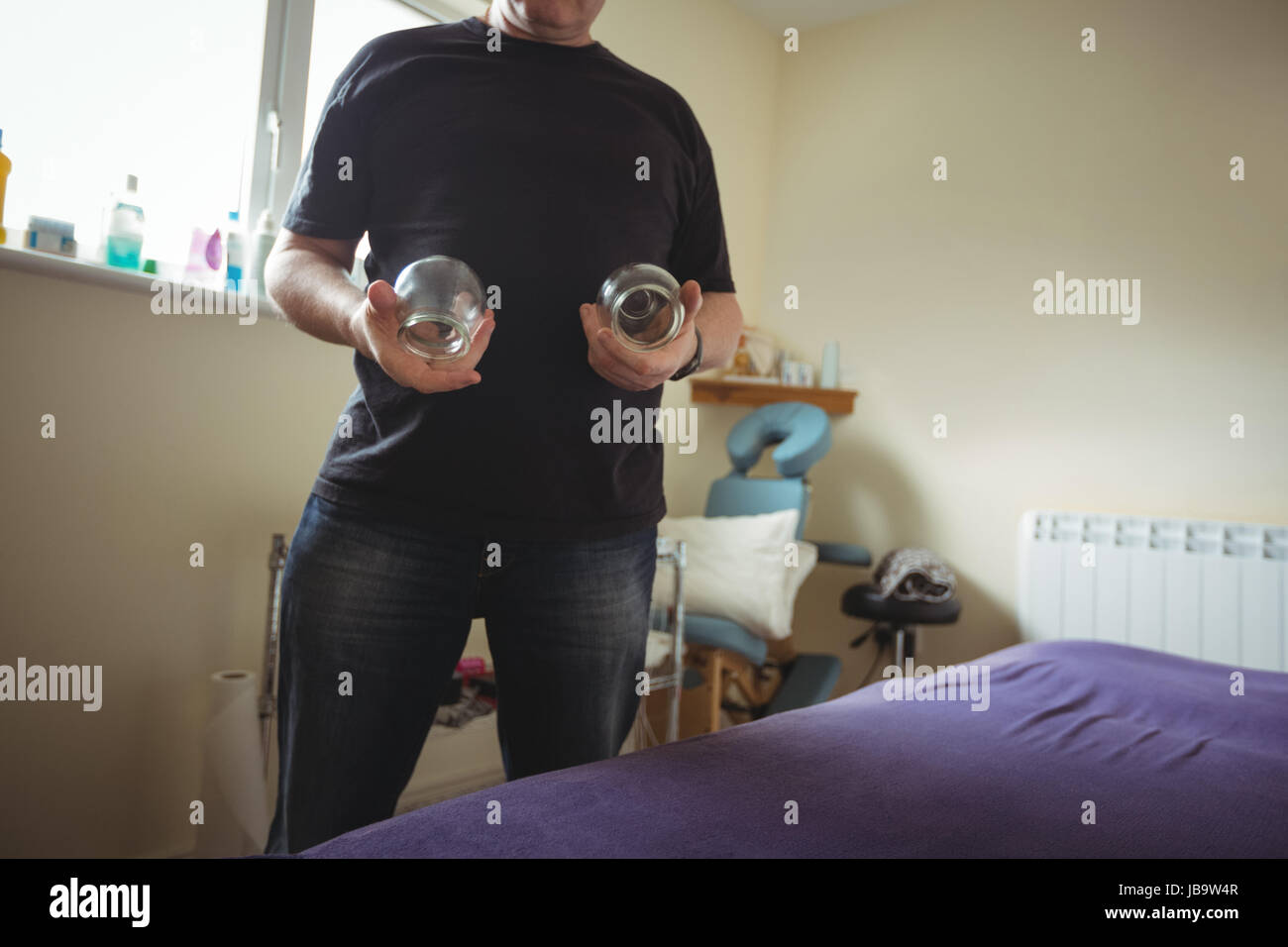 Therapist holding cupping glass in spa Stock Photo Alamy
