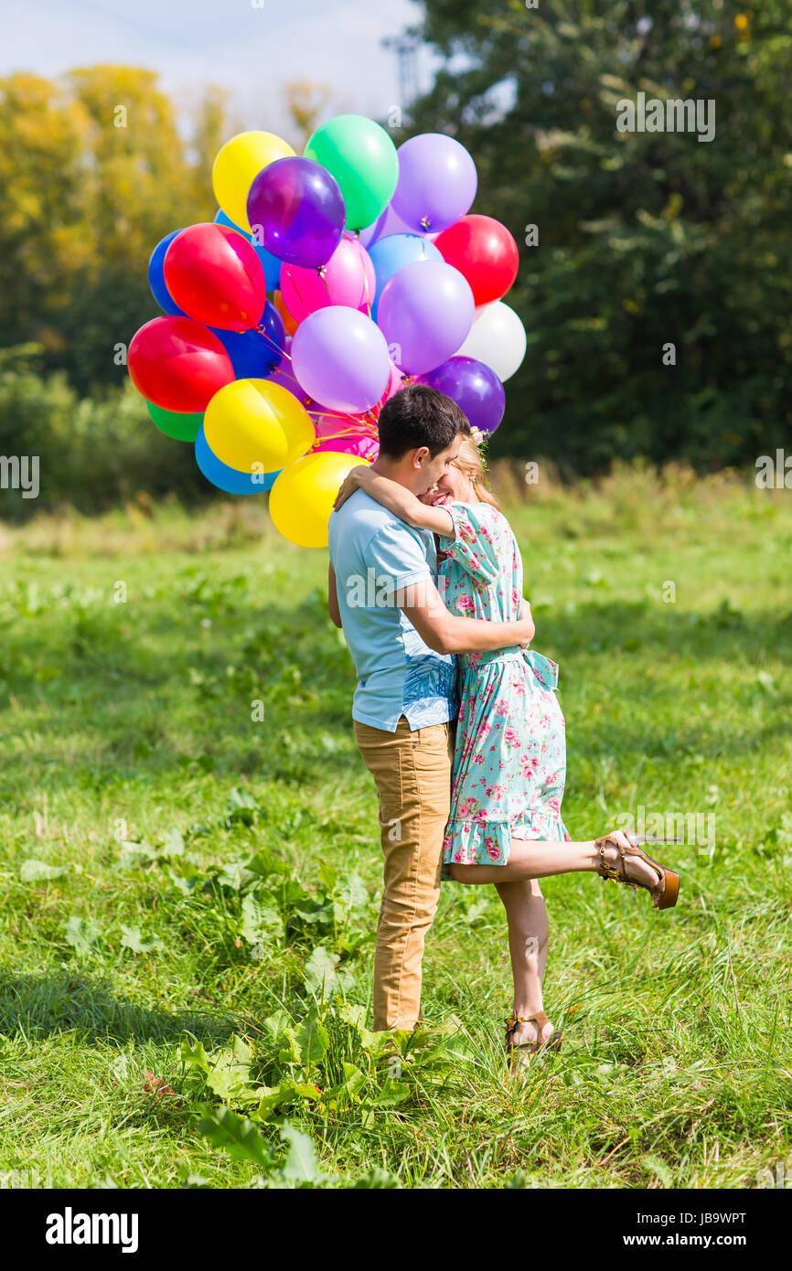 Young couple having weekend and walking with balloons on nature Stock ...