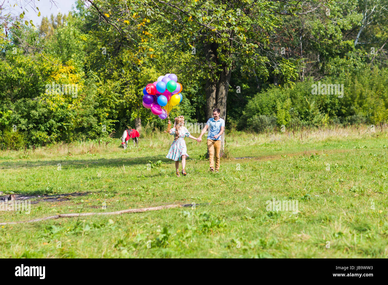 smiling couple in love with balloons in nature Stock Photo - Alamy