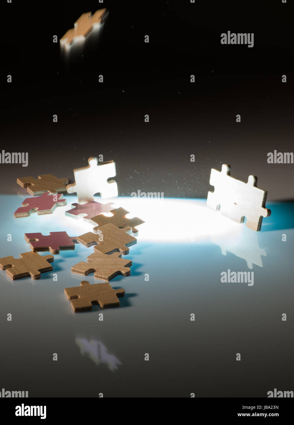 Falling puzzle pieces.Backlight background Stock Photo