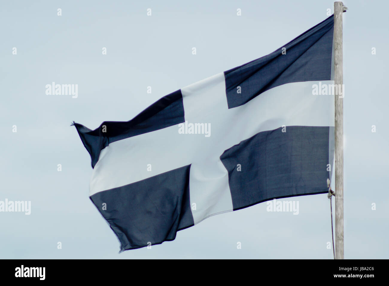 The Cornish Flag of St Piran blows in the wind Stock Photo
