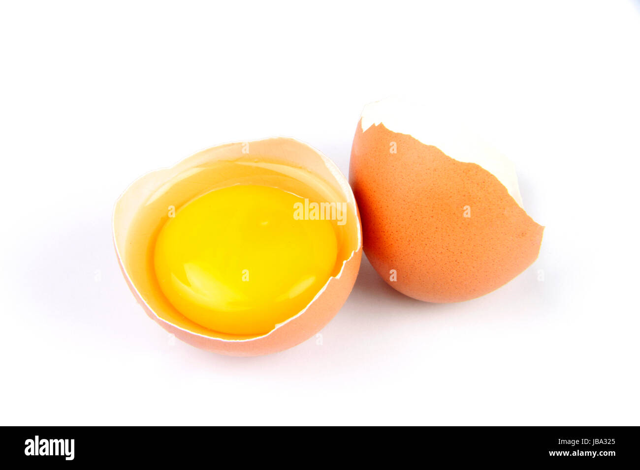 broken egg with yolk isolated on white background Stock Photo