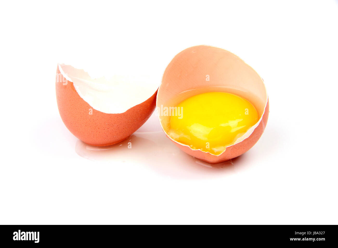 broken egg with yolk isolated on white background Stock Photo