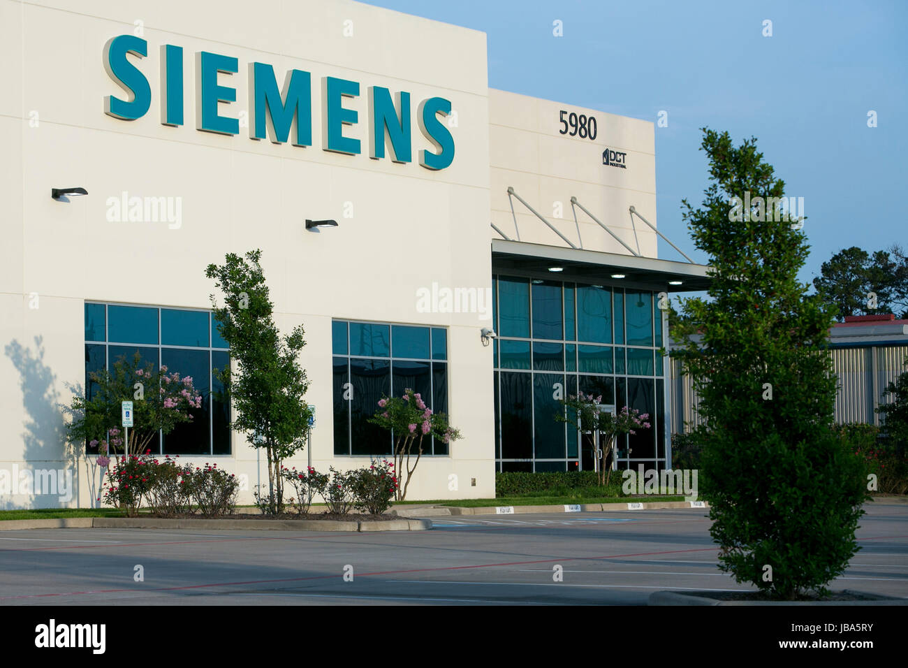 A logo sign outside of a facility occupied by Siemens AG in Houston