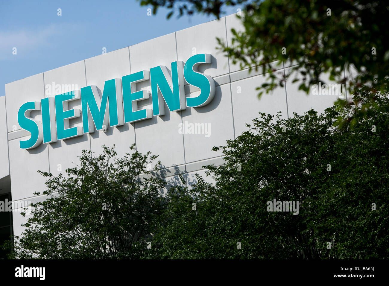 A logo sign outside of a facility occupied by Siemens AG in Houston