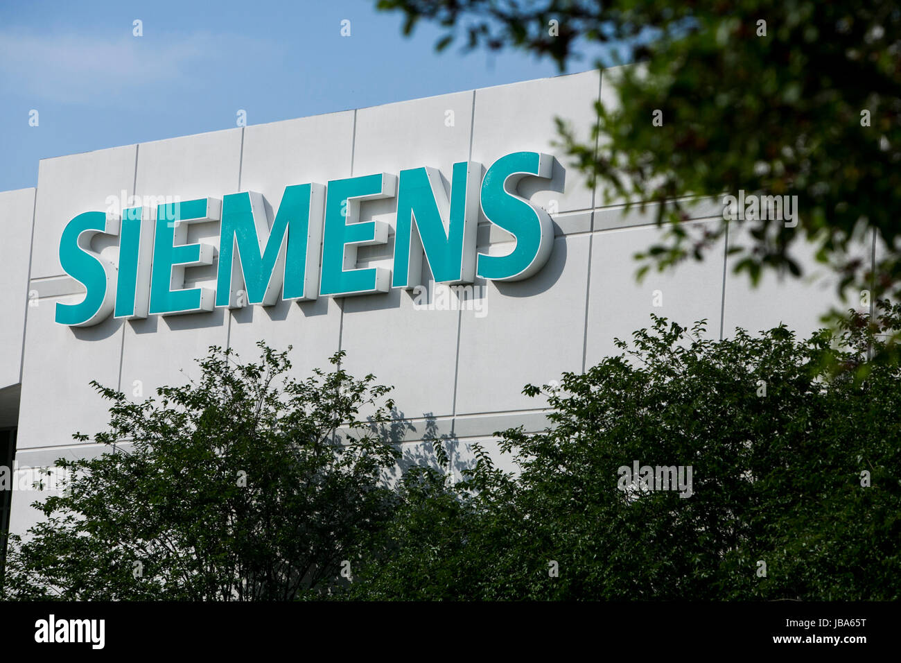 A logo sign outside of a facility occupied by Siemens AG in Houston