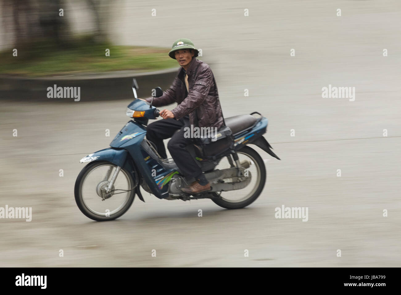 Old man on scooter, Ninh Binh, Vietnam Stock Photo