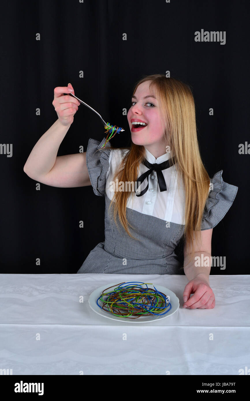 young woman eating the cables Stock Photo - Alamy