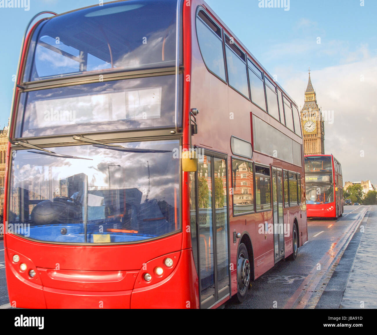 London double decker bus crossing Westminster Bridge in front of the Houses of Parliament and Big Ben Stock Photo