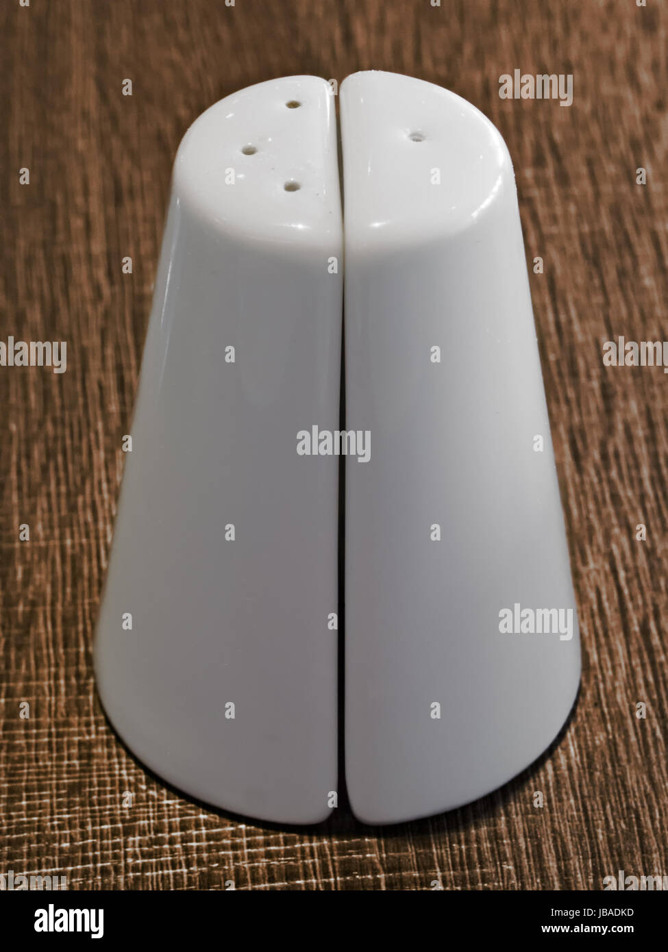 close up of white ceramic salt and pepper shaker set Stock Photo