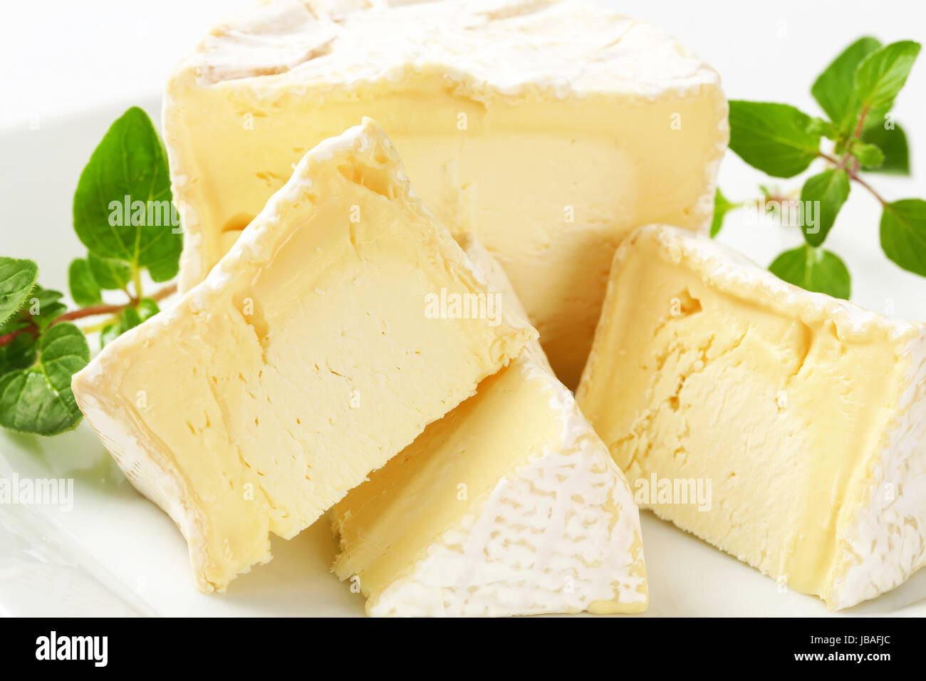Wedges of French white rind cheese Stock Photo - Alamy