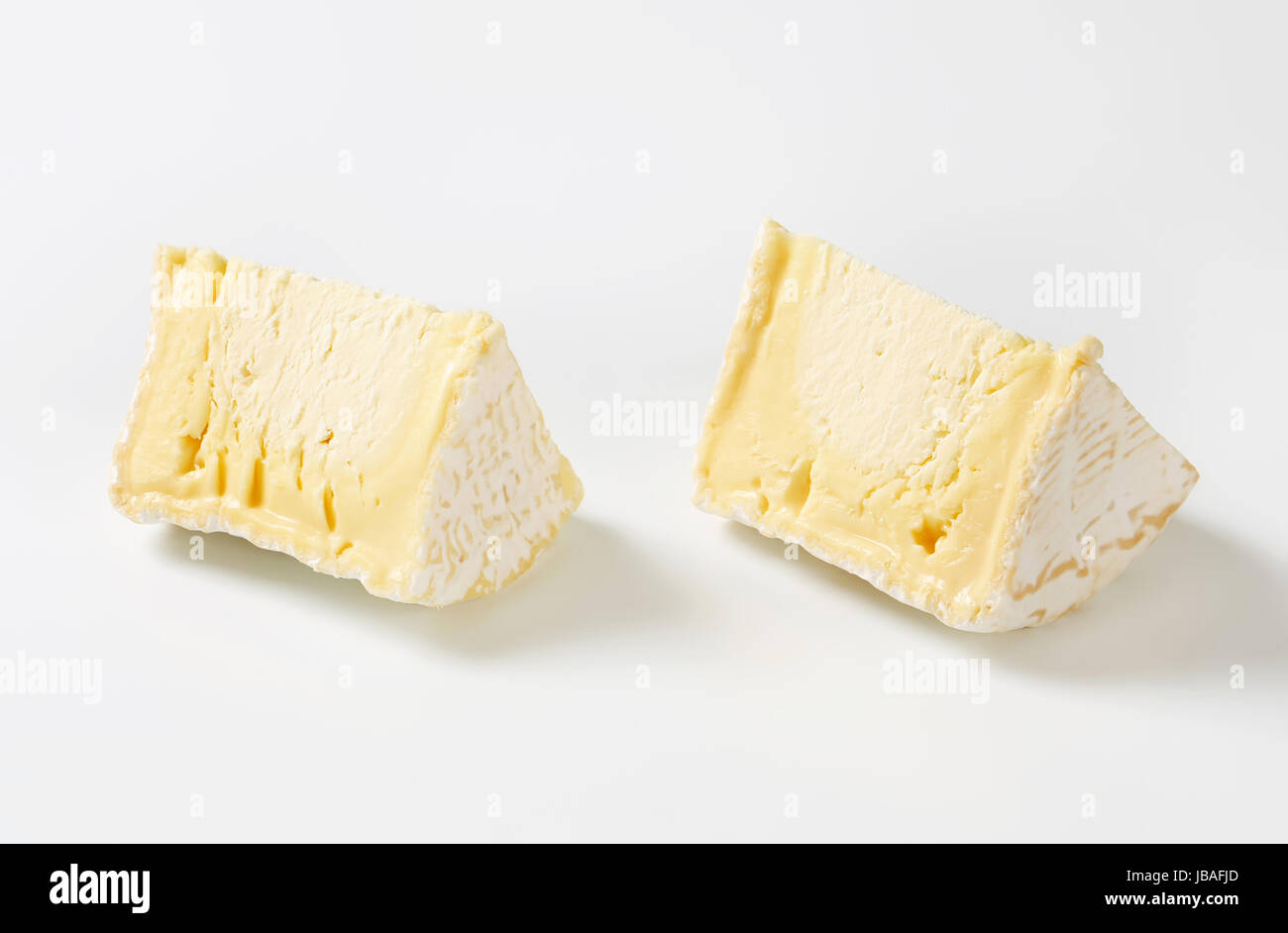 Wedges of French white rind cheese Stock Photo - Alamy