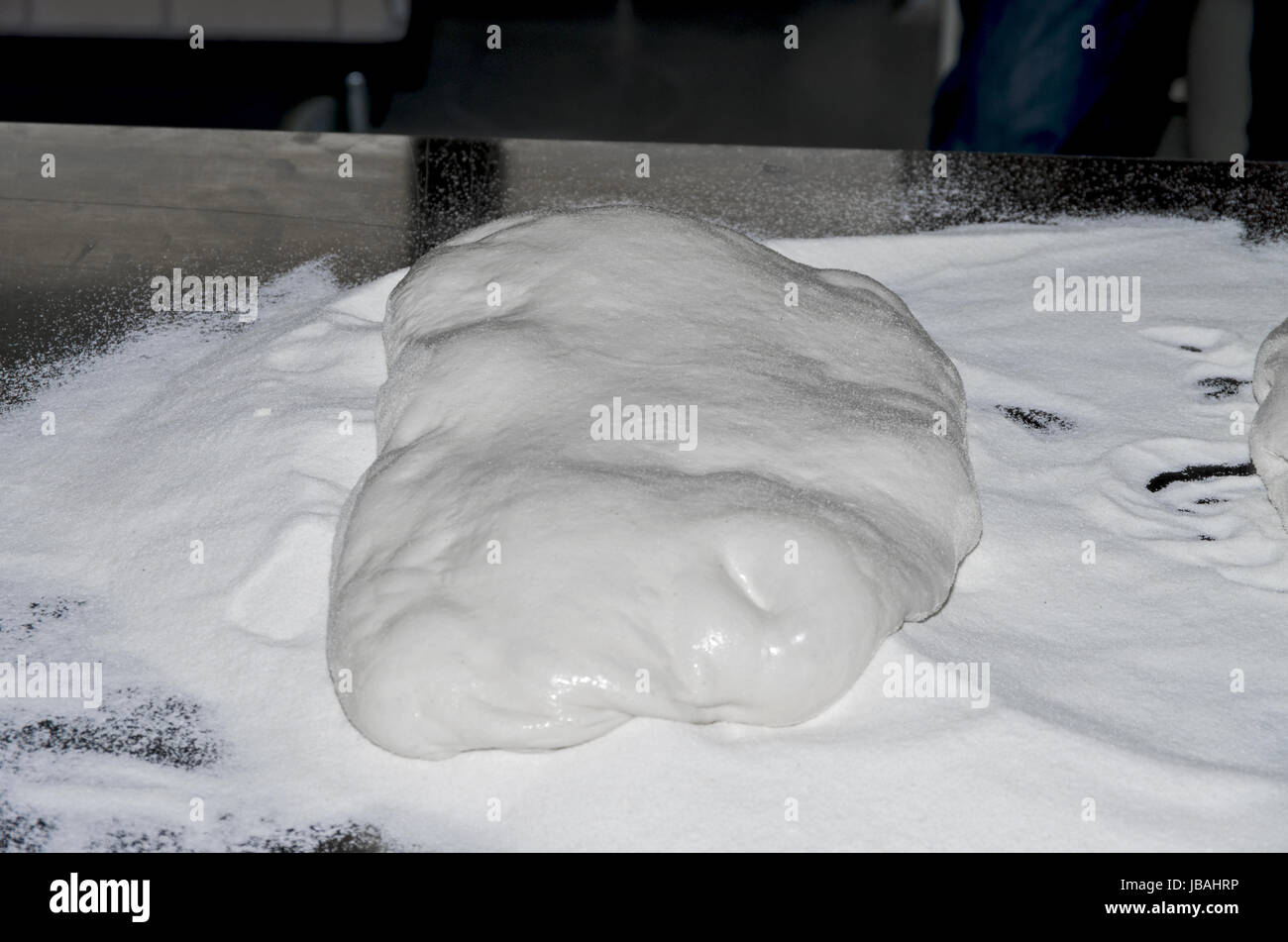 Handling, working and cooking pizza dough with shovel Stock Photo