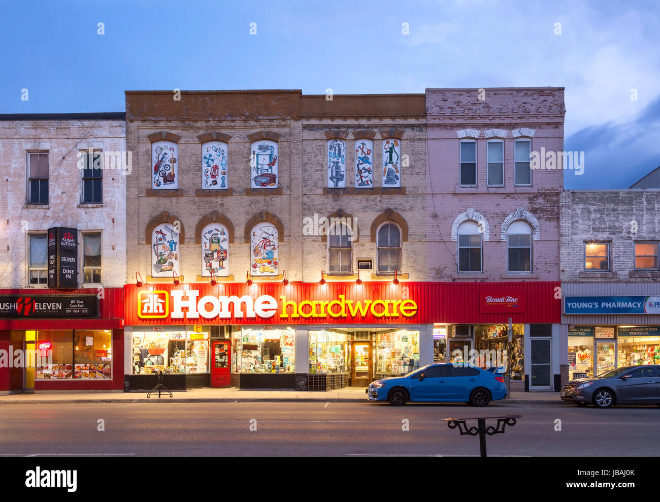 A Home Hardware store that occupies a historical heritage building in downtown Ingersoll, Oxford County, Ontario, Canada at dusk. Stock Photo