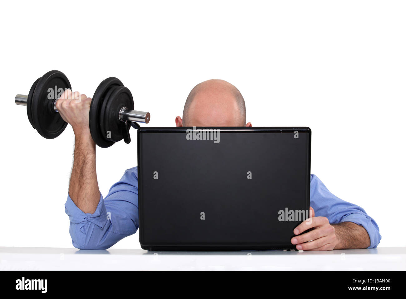 Businessman using weights Stock Photo - Alamy