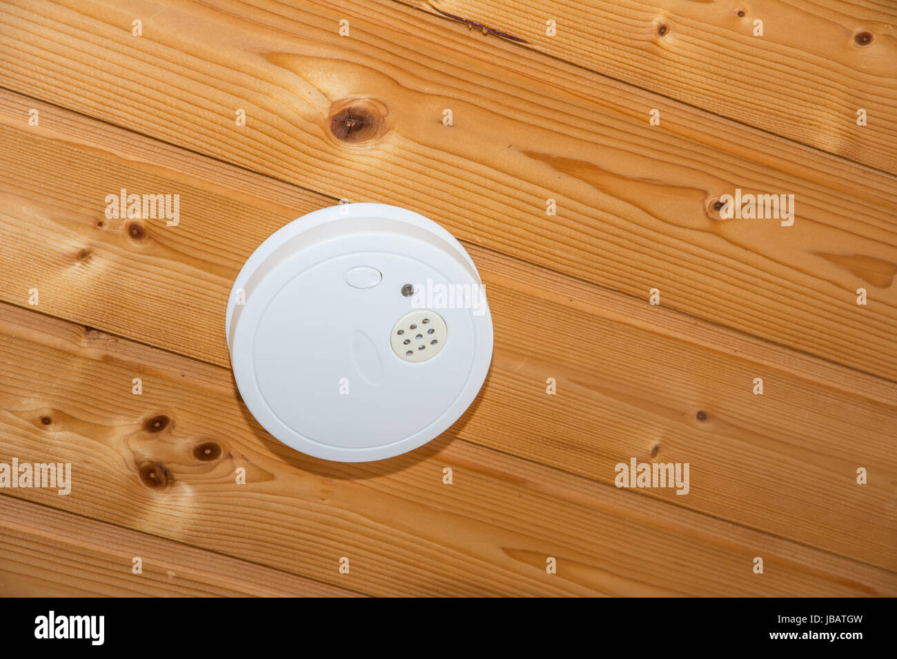 Fire safety with a smoke detector on a wooden ceiling Stock Photo - Alamy