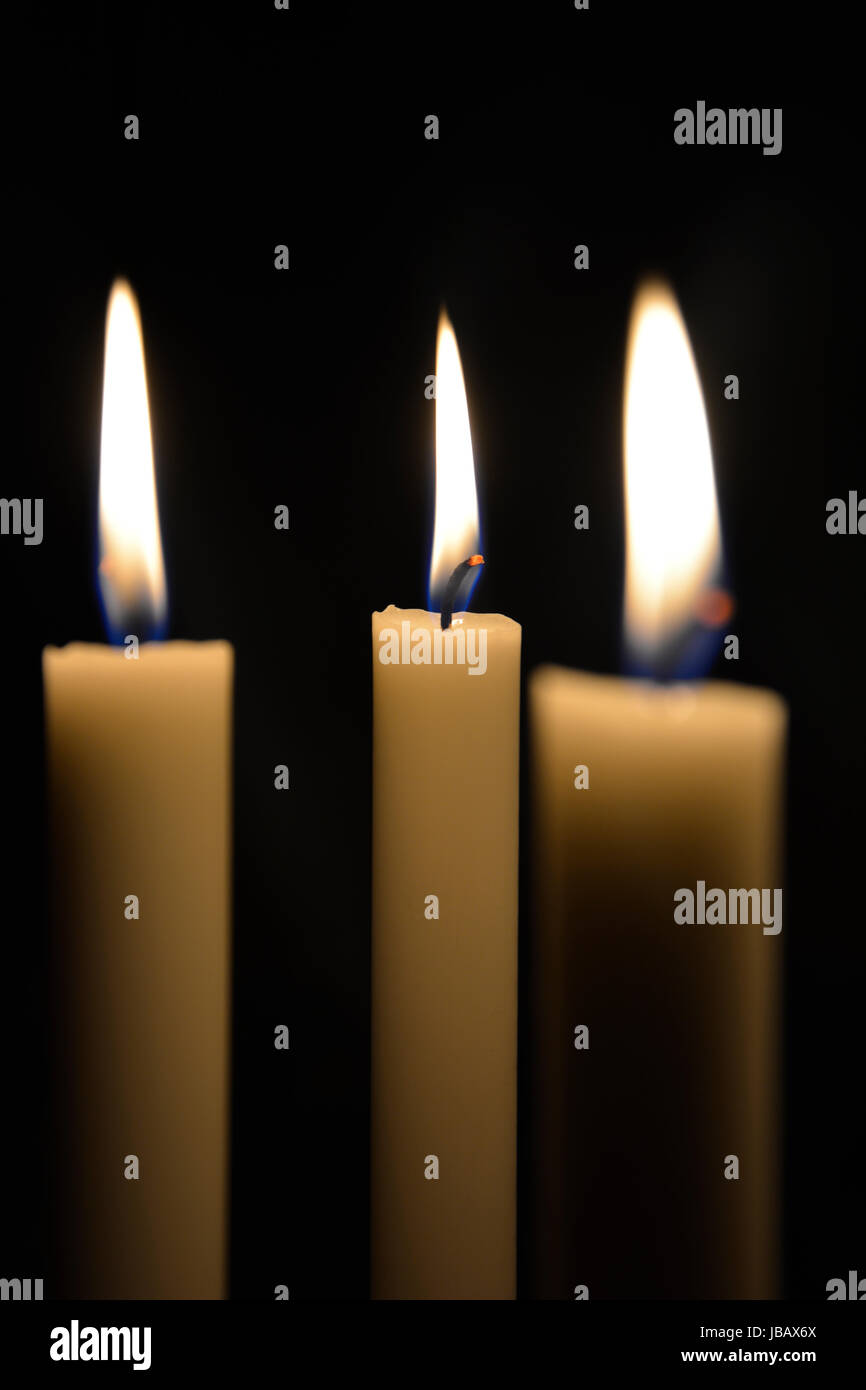 three white candles Stock Photo Alamy