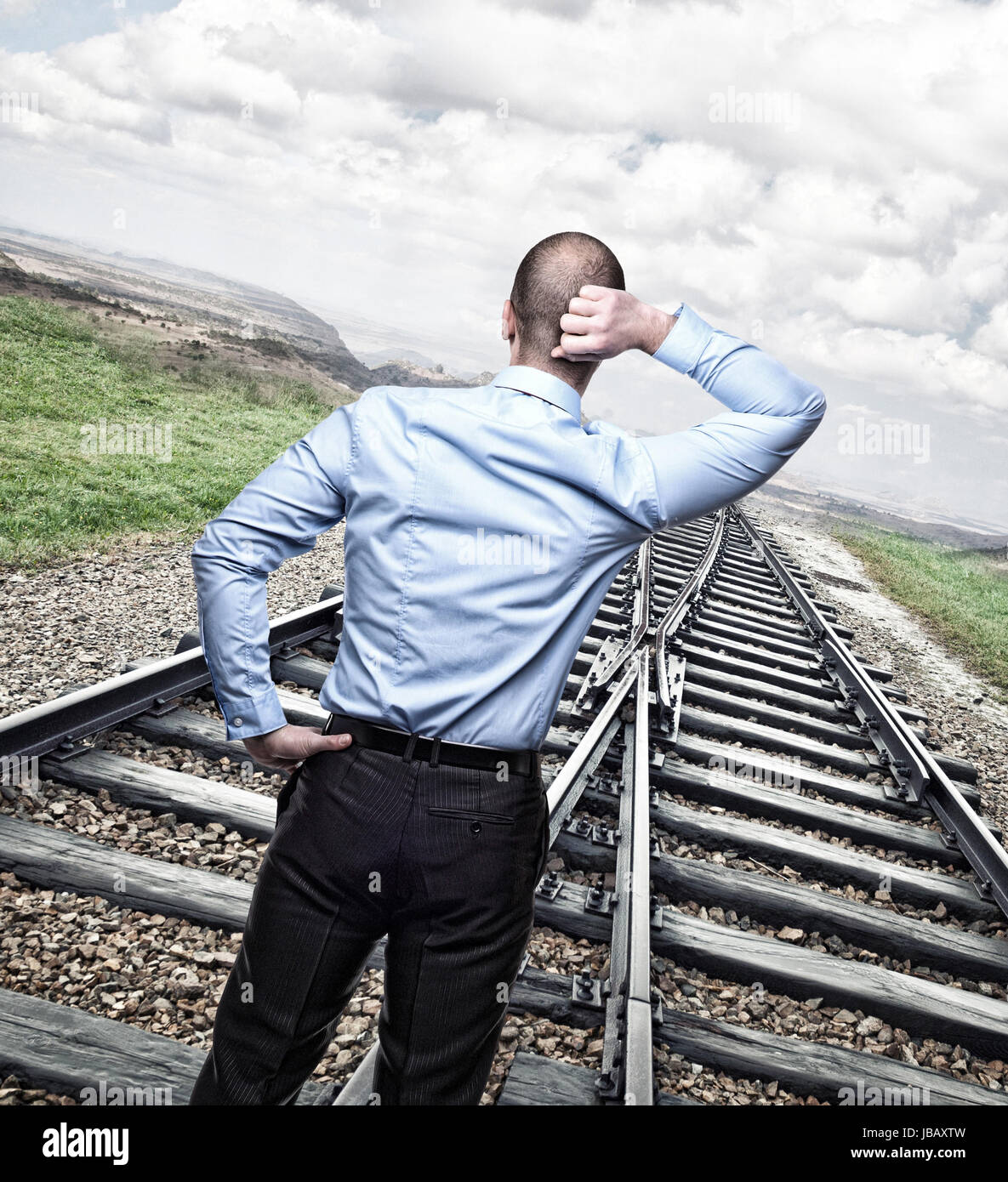 thinking businessman on train rail Stock Photo