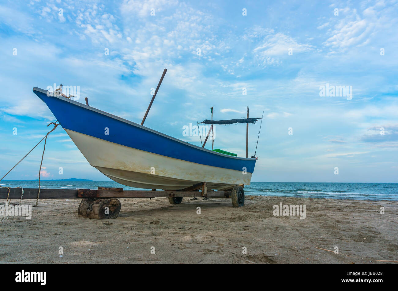 Traditional wooden boat at sea shore with blue skies Stock Photo - Alamy