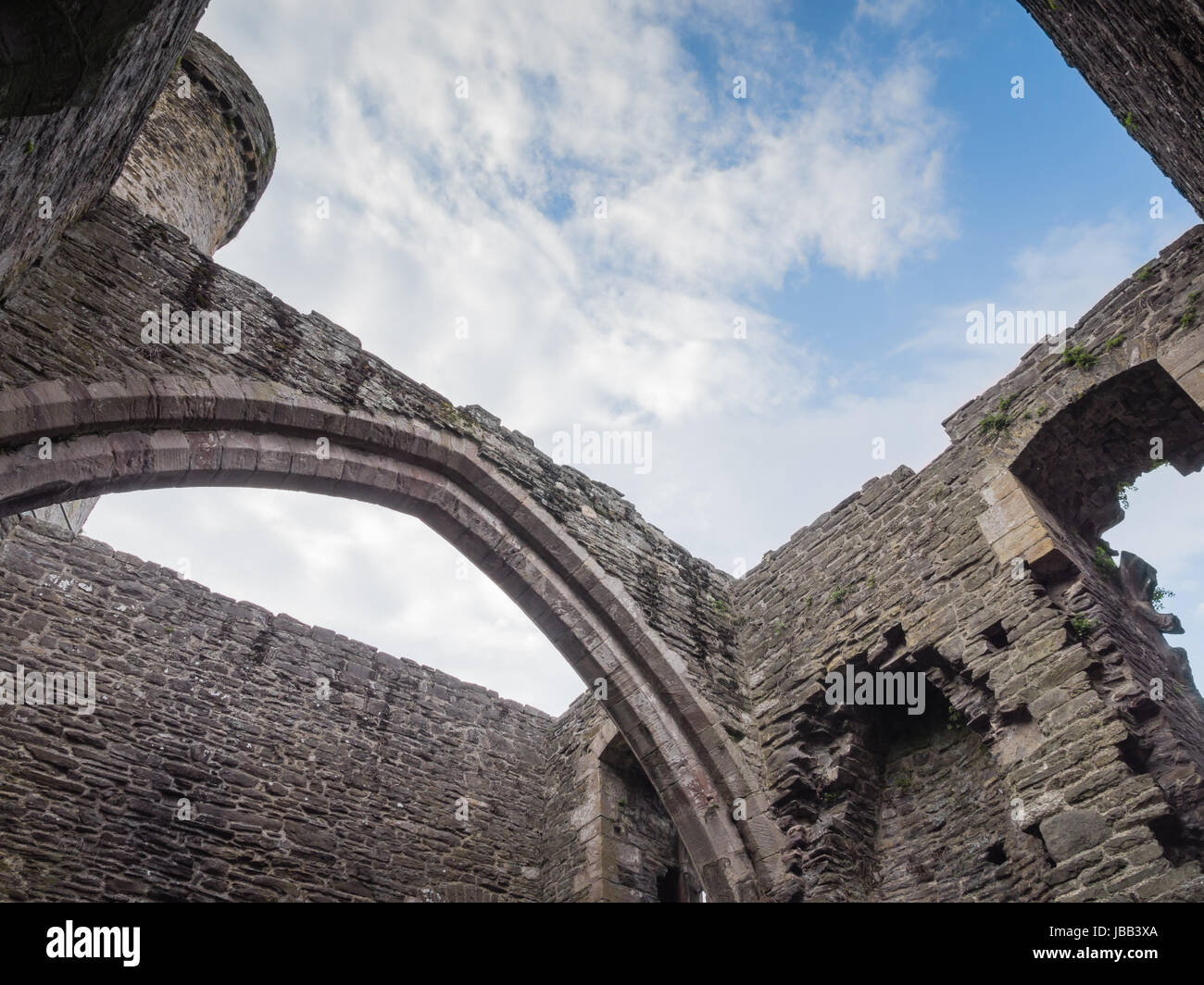 View to the sky from inside massive Conwy Castle in Wales built by king Edward I as one of the fortifications during the conquest of Wales in the 13th Century Stock Photo