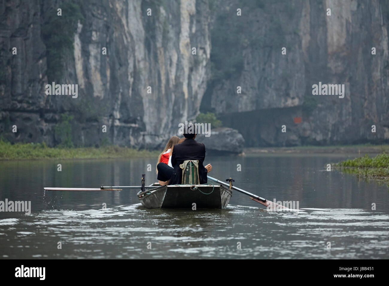 Tourists on Tam Coc (three caves) boat trip on Ngo Dong River, (UNESCO World Herritage Area), near Ninh Binh, Vietnam Stock Photo