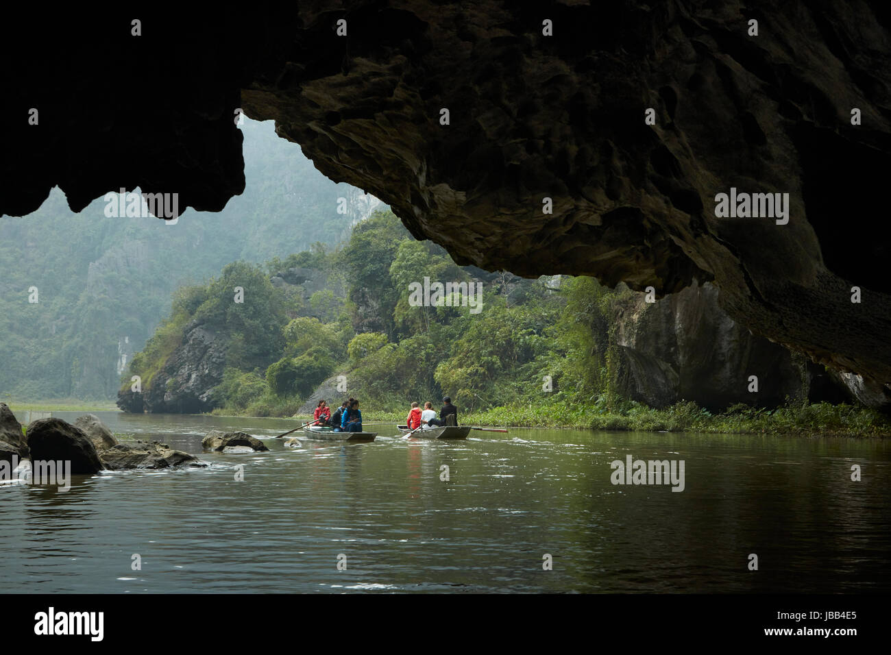 Tourists in cave on Tam Coc (three caves) boat trip on Ngo Dong River, (UNESCO World Herritage Area), near Ninh Binh, Vietnam Stock Photo