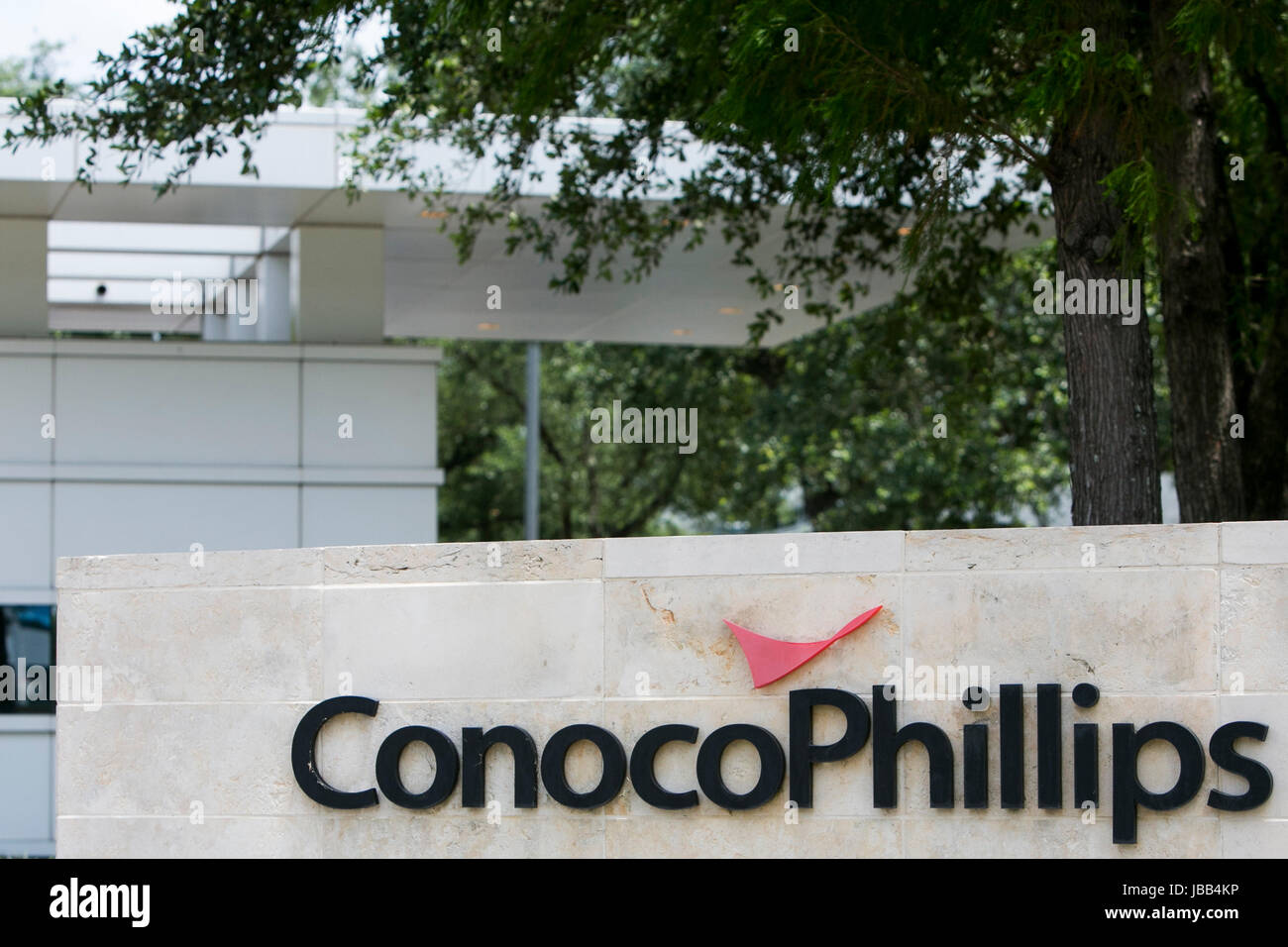 A logo sign outside of the headquarters of the ConocoPhillips Co., in Houston, Texas, on May 27, 2017. Stock Photo