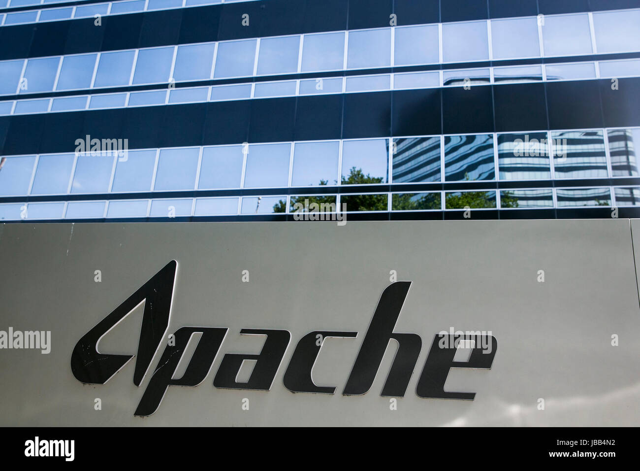 A logo sign outside of the headquarters of the Apache Corporation in