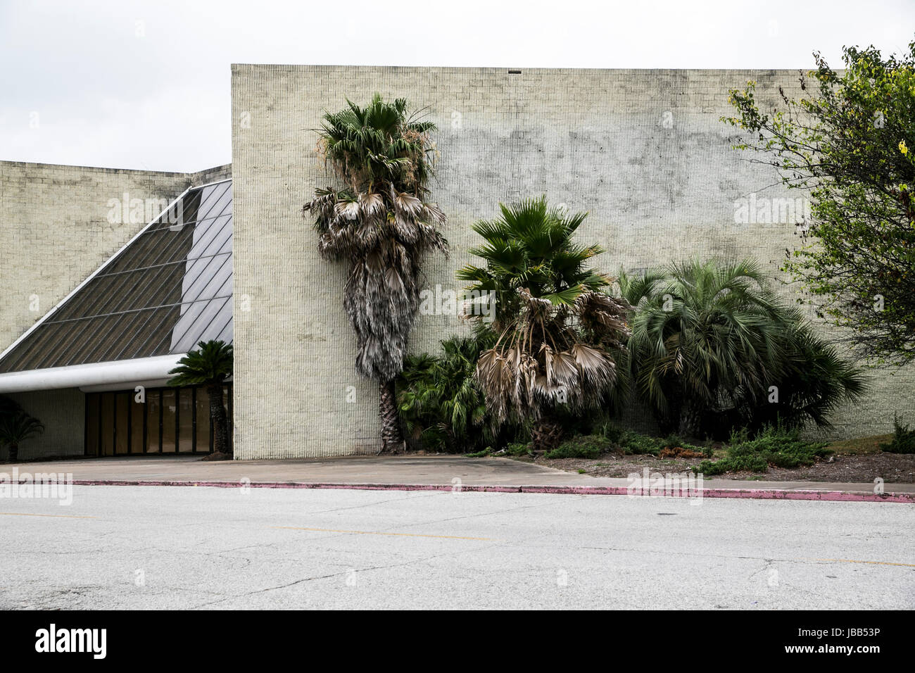 The faded outline of a Macy’s logo at a closed mall retail store