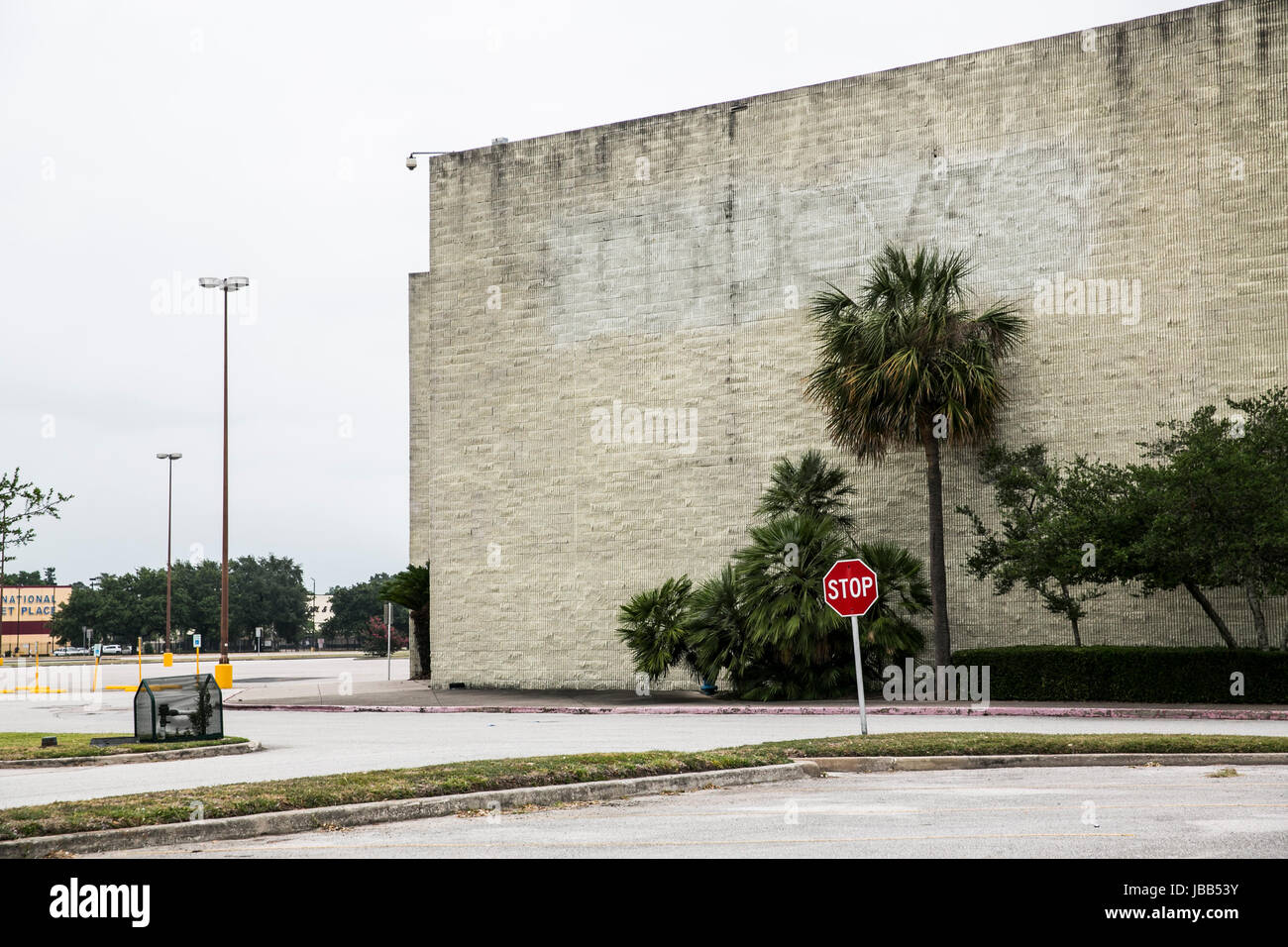 The faded outline of a Macy’s logo at a closed mall retail store
