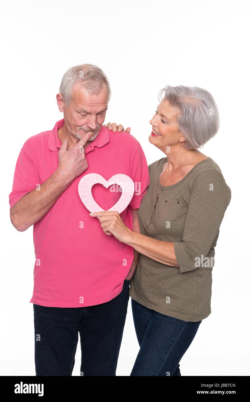 Senioren mit einem Herz vor weißem Hintergrund Stock Photo
