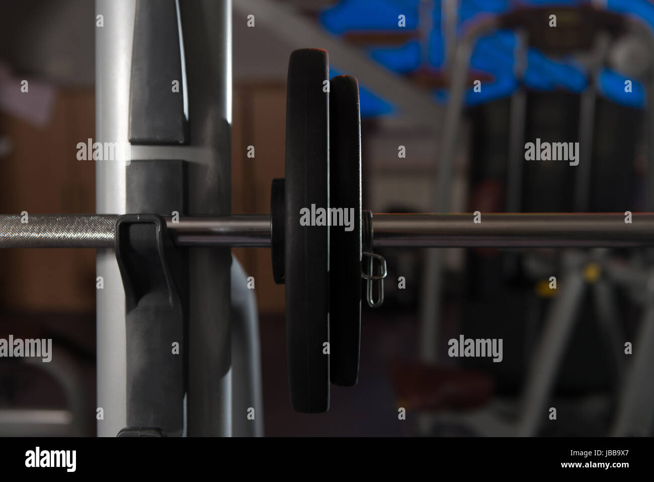 Barbell and Weights at the Modern Gym Room Fitness Center Stock Photo