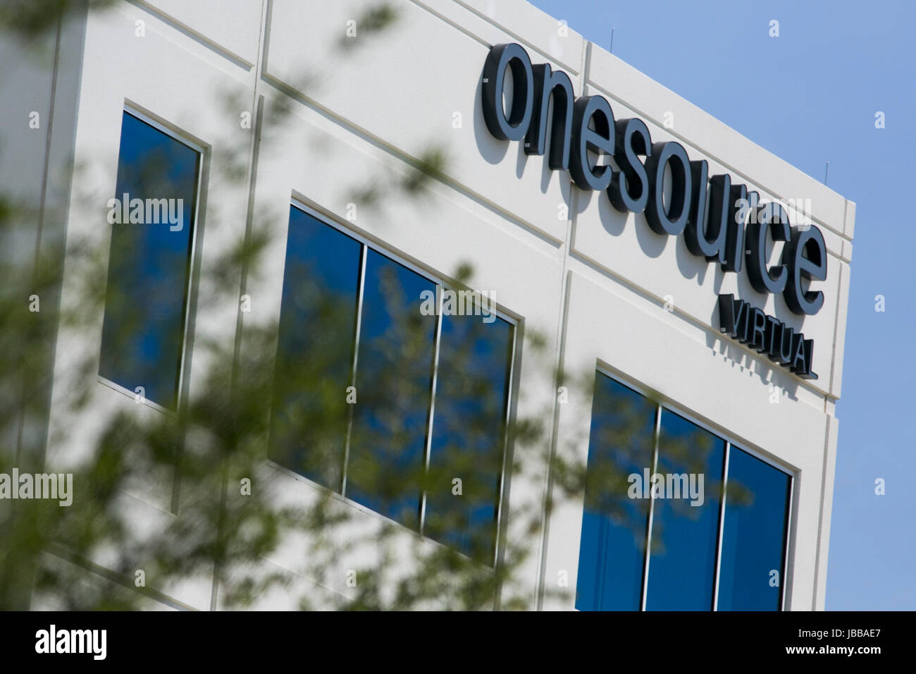 A Logo Sign Outside Of A Facility Occupied By OneSource Virtual In ...