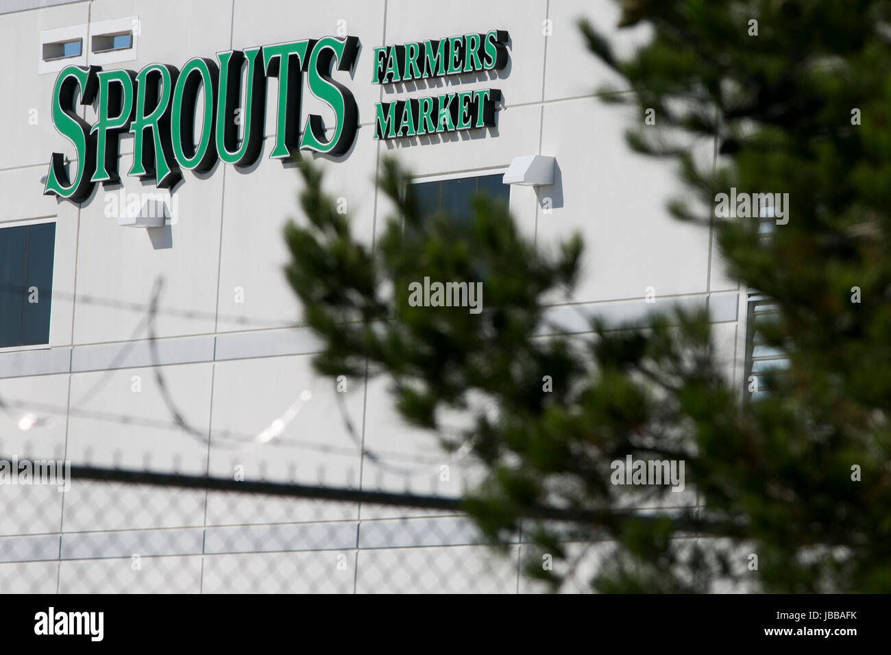 A logo sign outside of a Sprouts Farmers Market, Inc., distribution