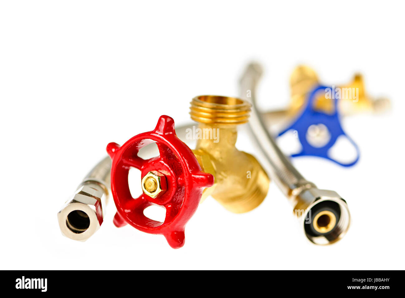 Isolated plumbing valves hoses and assorted parts Stock Photo