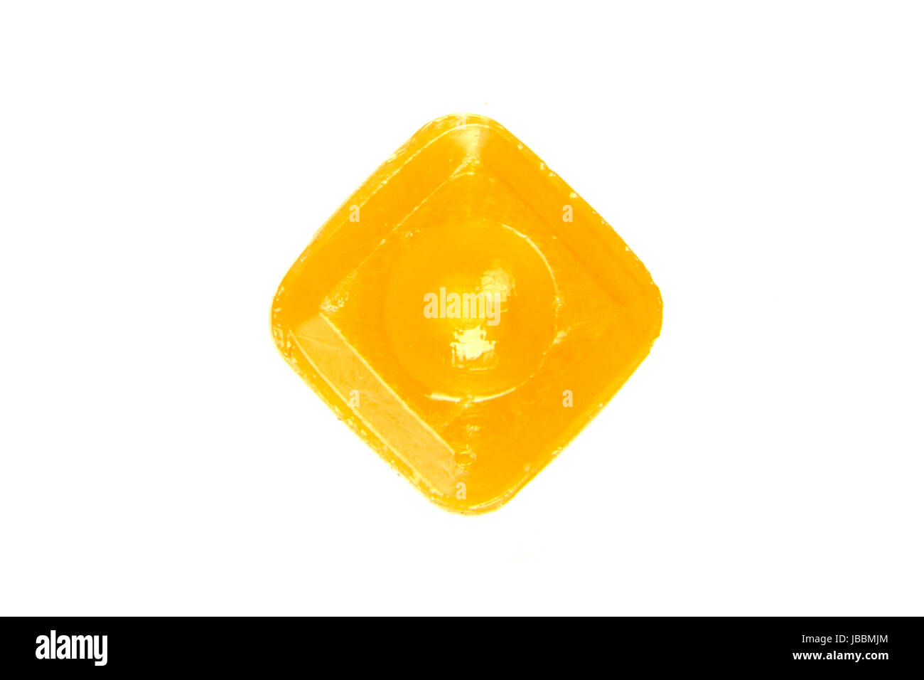 one orange flavoured hard candy isolated on the white background Stock