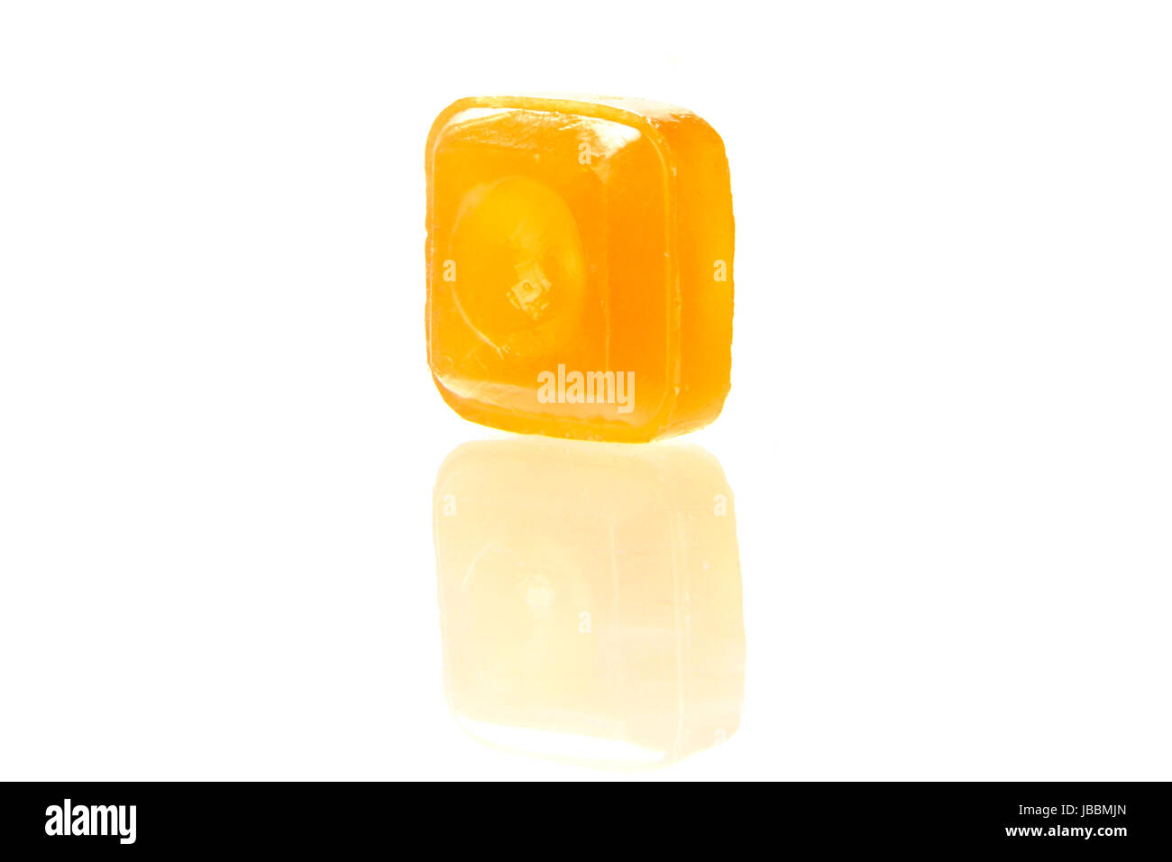 orange flavoured hard candy isolated on the white background Stock