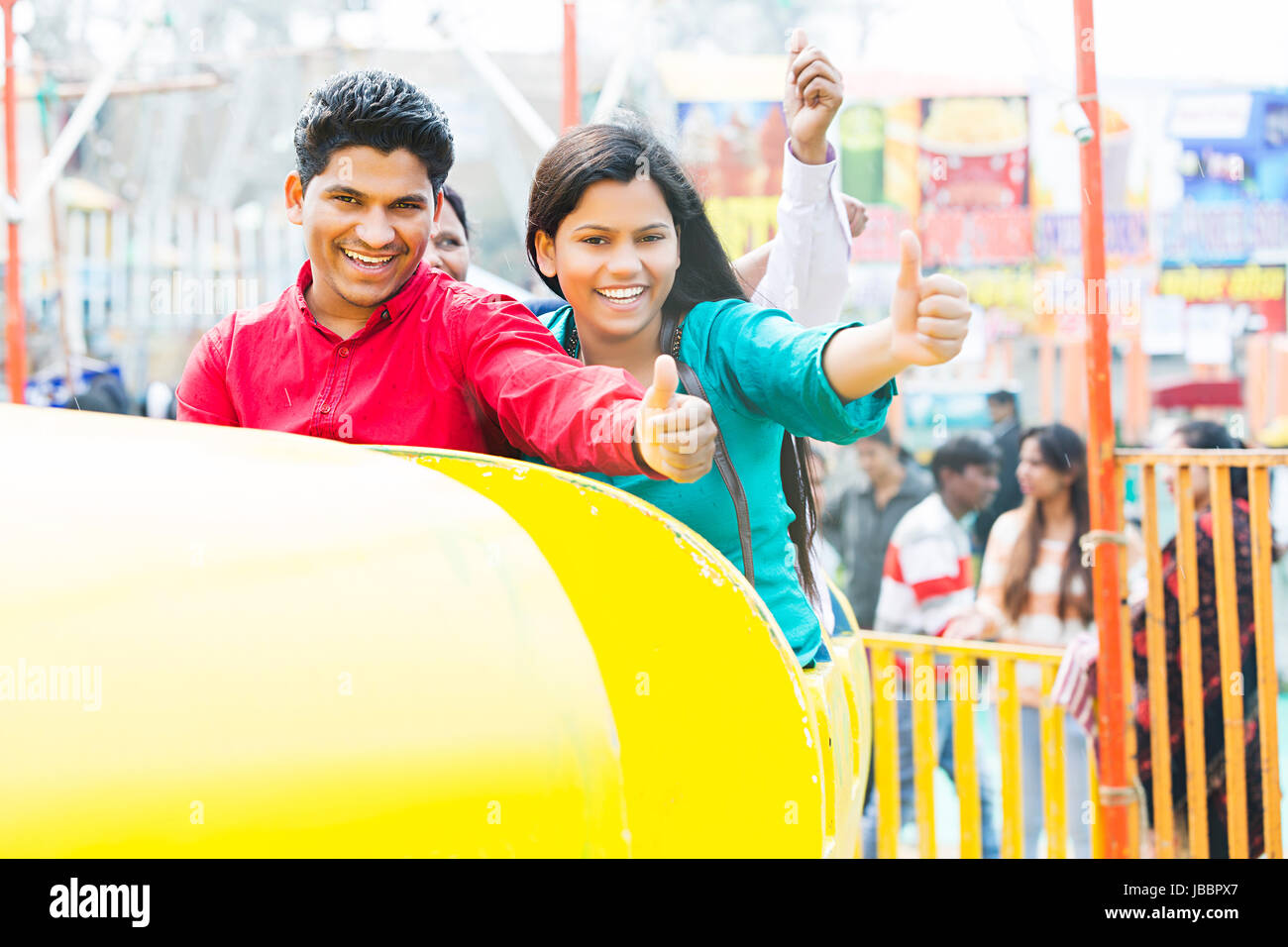 Happy 2 Indian Young man And Woman Showing Thumbs up Market In Suraj