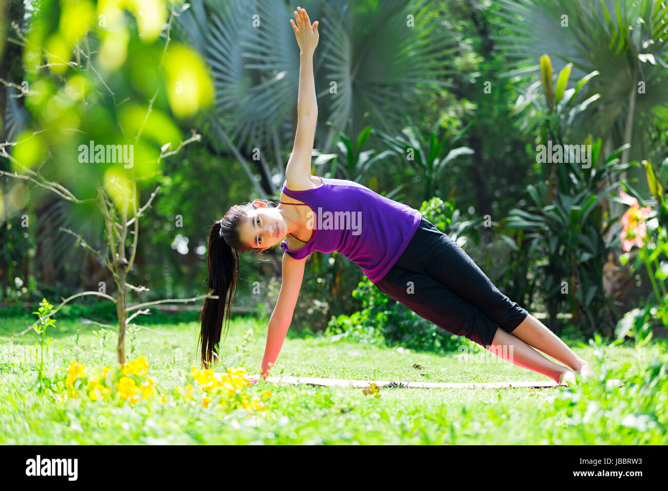 1 Indian Young Girl Stretching Work-Out Morning Exercise In Park Stock Photo