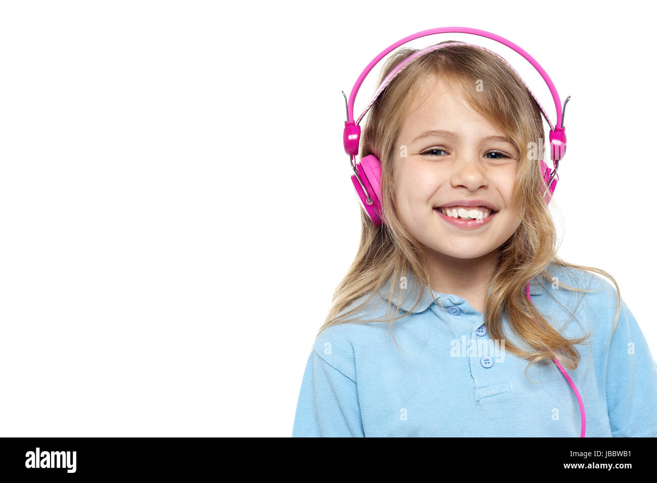 Cheerful young girl posing with her pink headphones on.Isolated over