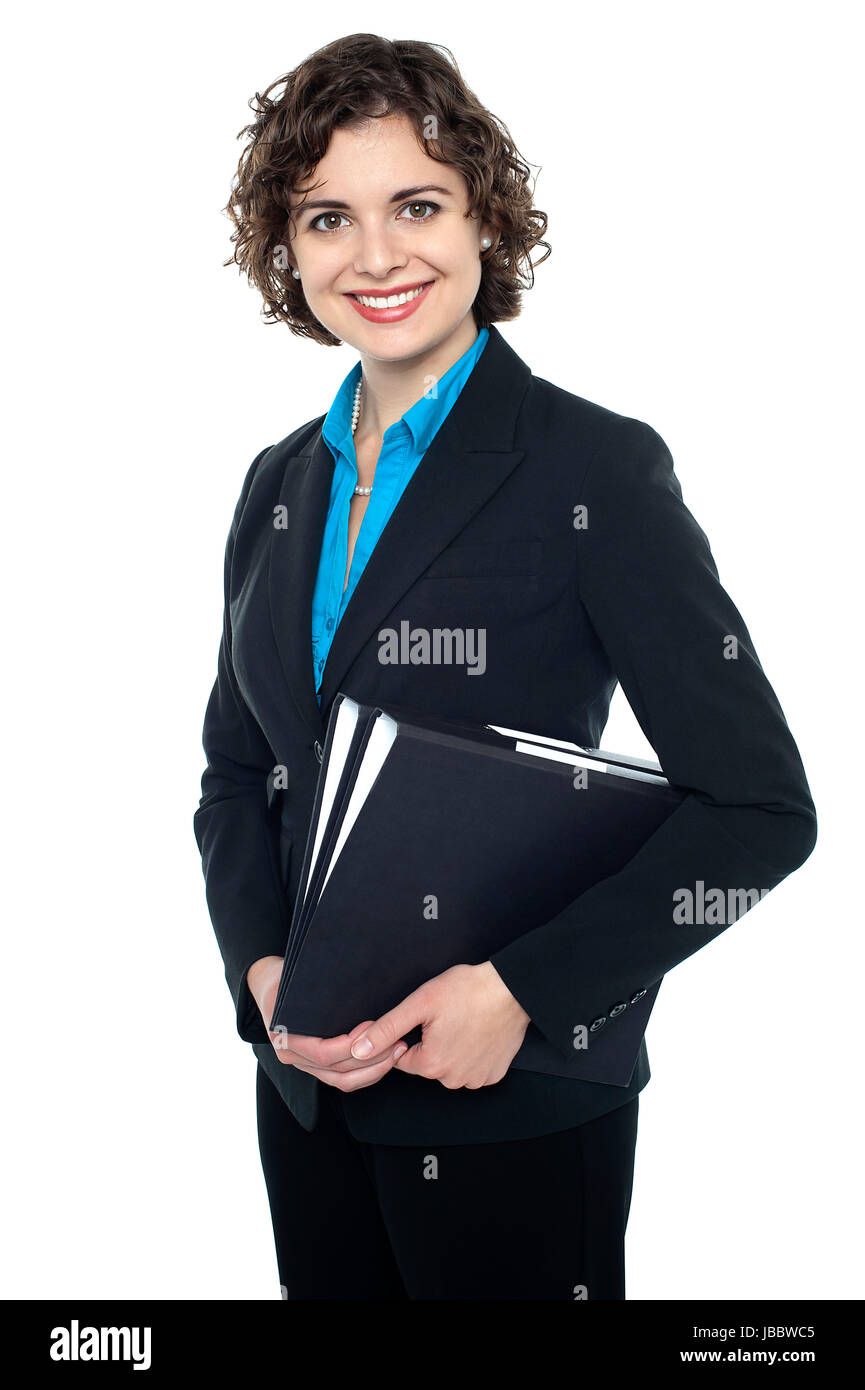 Ambitious businesswoman with files in hand posing in front of camera