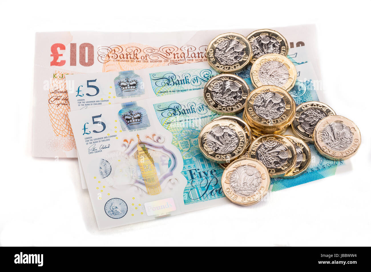 British one pound coins on British bank notes Stock Photo