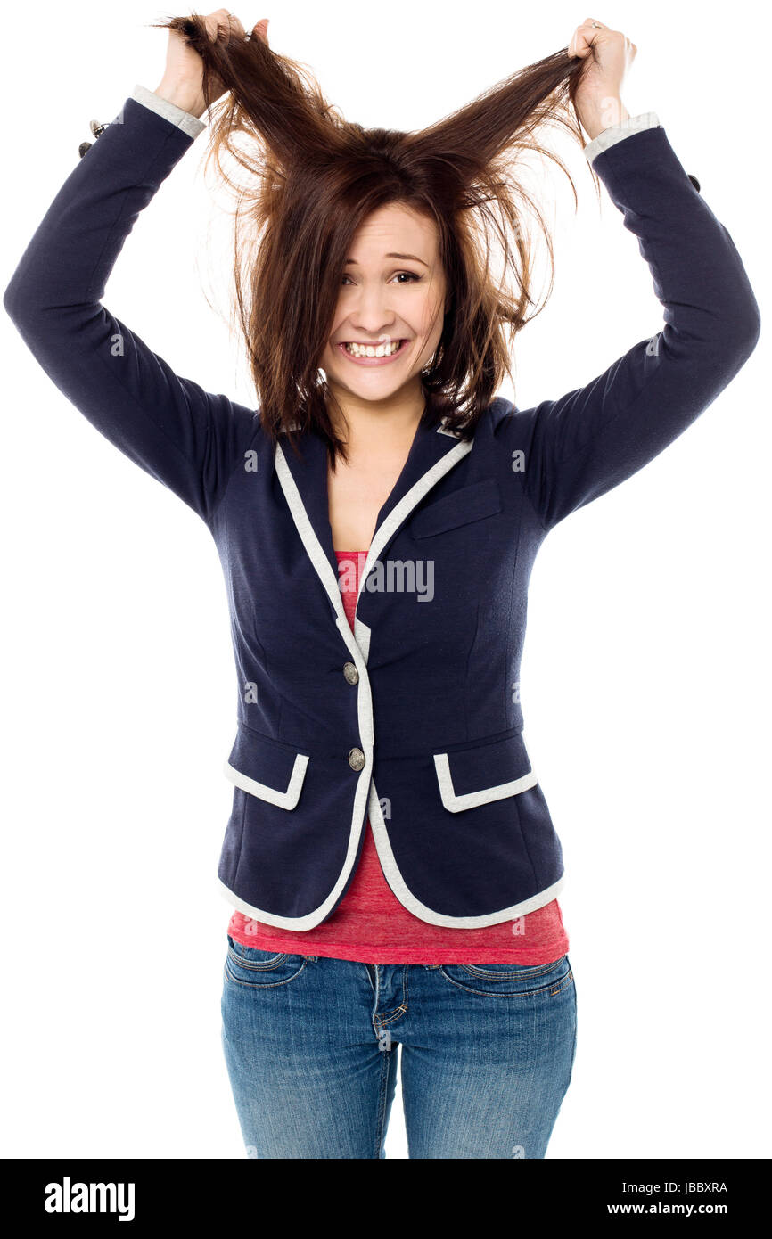 Playful young female pulling her hair out in madness Stock Photo Alamy