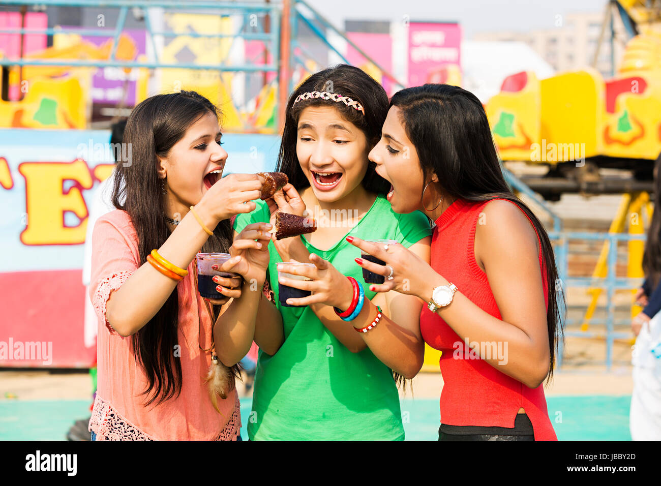 3 Teenager Girls Friends Eating Ice Cream Greed ing Enjoying Fair Stock Photo