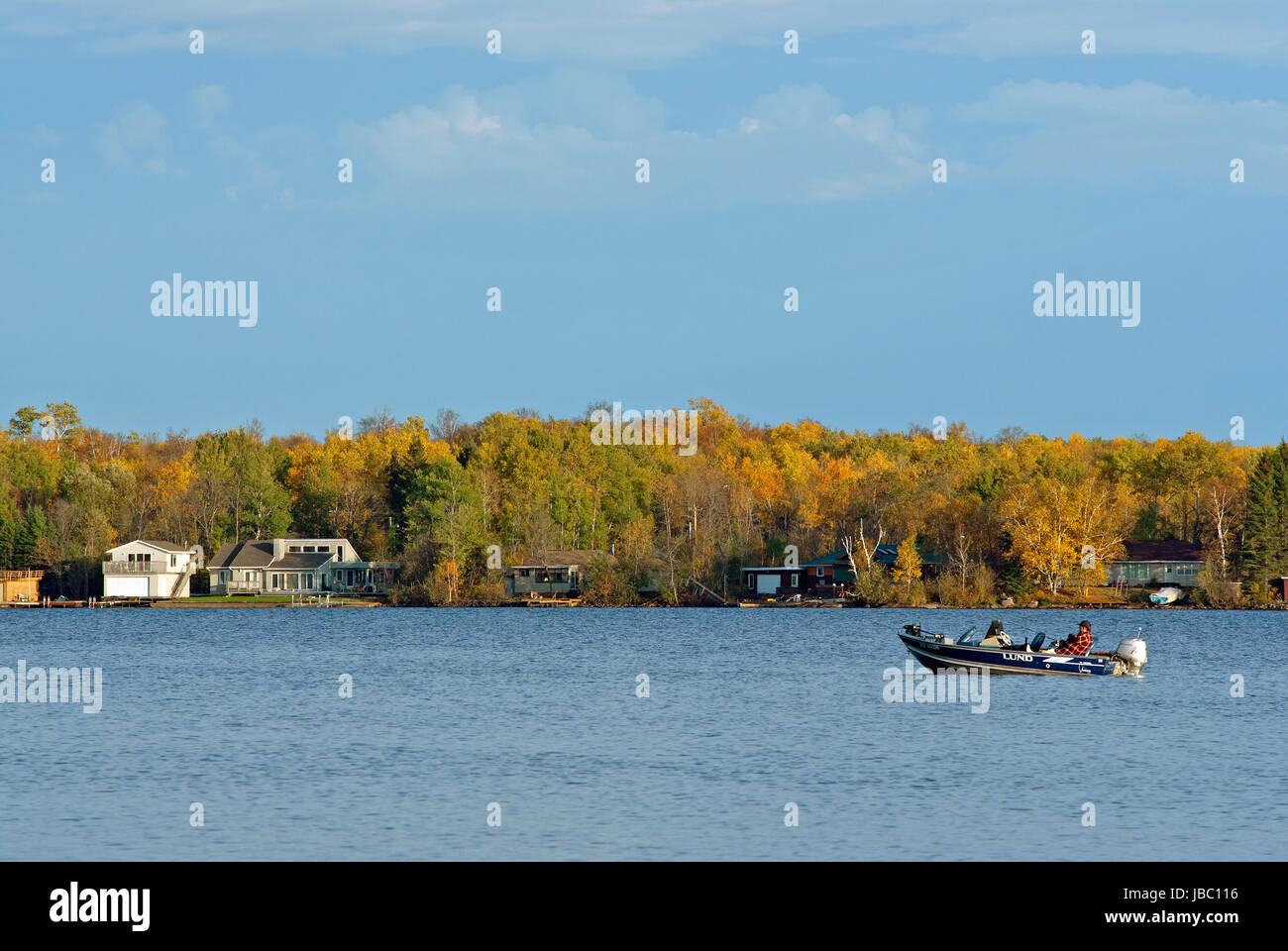 Boat with fisherman on the Falcon Lake, Whiteshell Provincial Park