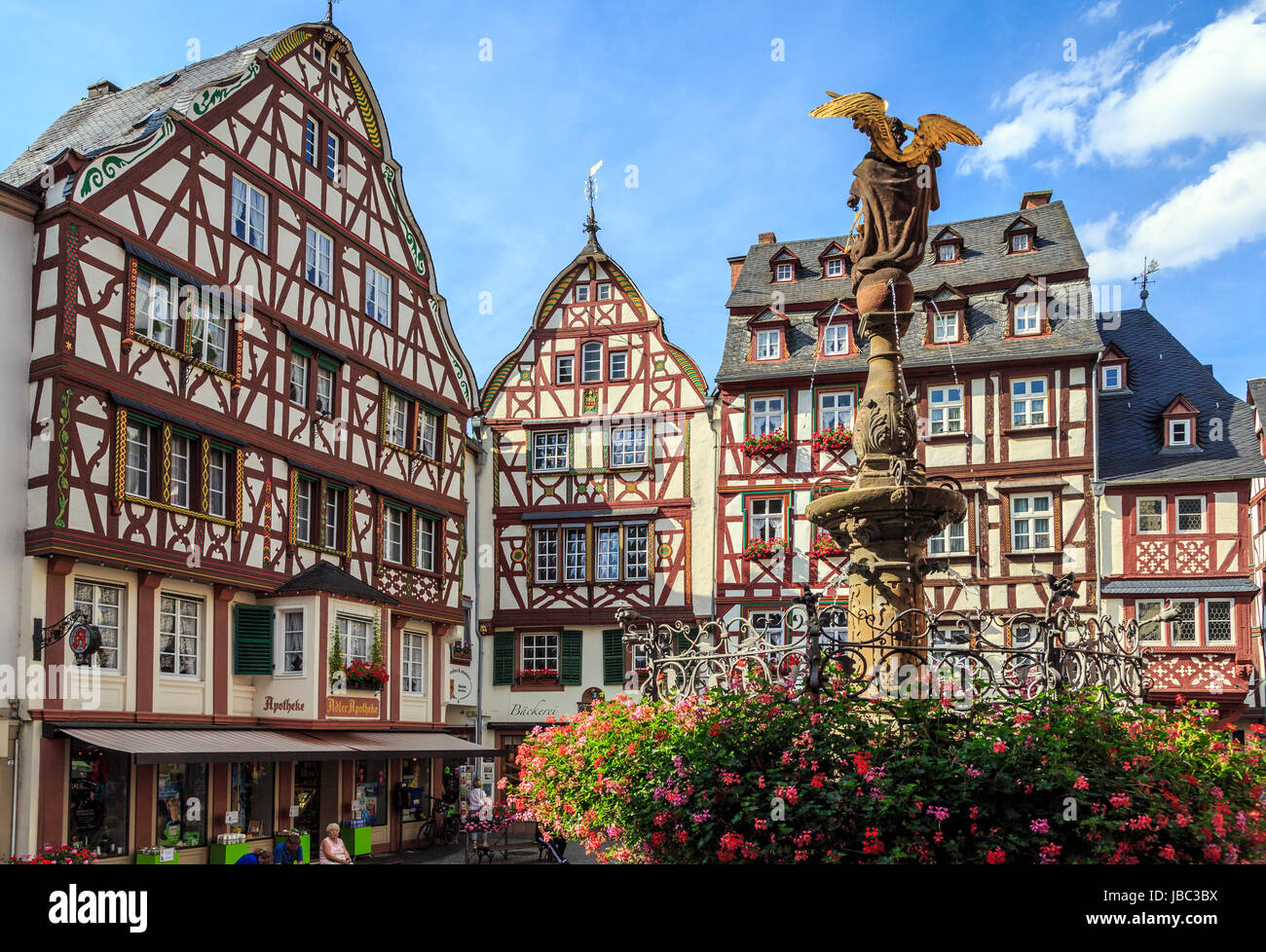 BERNKASTEL, GERMANY - AUGUST 05: Tourists stroll on August 05, 2013 in Bernkastel-Kues, Germany. According to its Tourism Office, the town is annually visited by 1.5m tourists. Region is famous for wines. Stock Photo