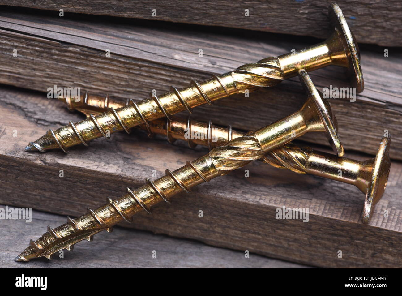 Macro Gold Metal Thread Screw and Wooden Plank Stock Photo