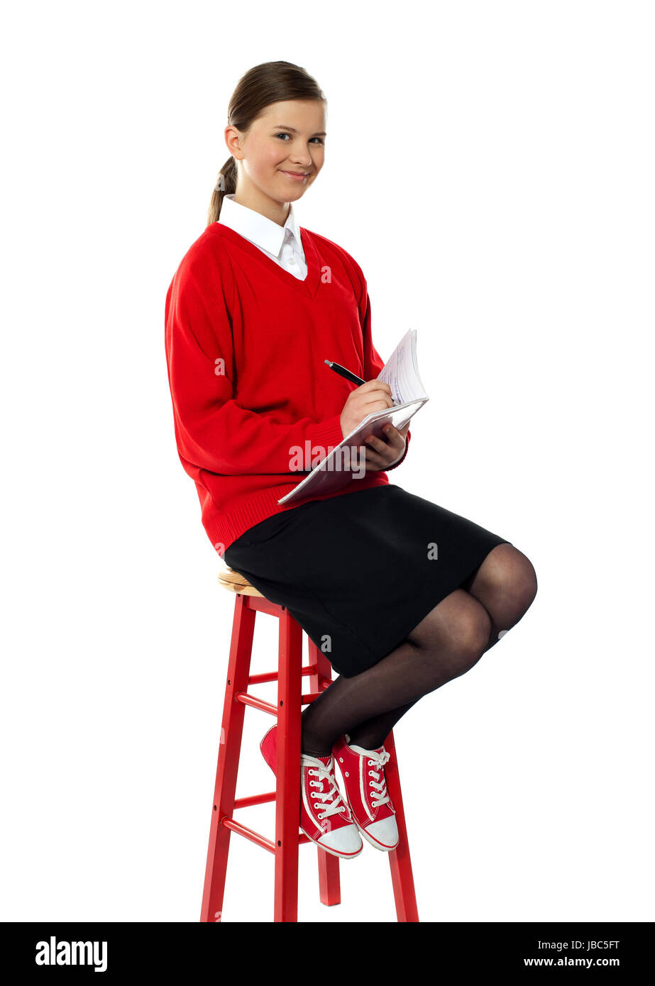 Girl sitting on stool writing hi-res stock photography and images - Alamy